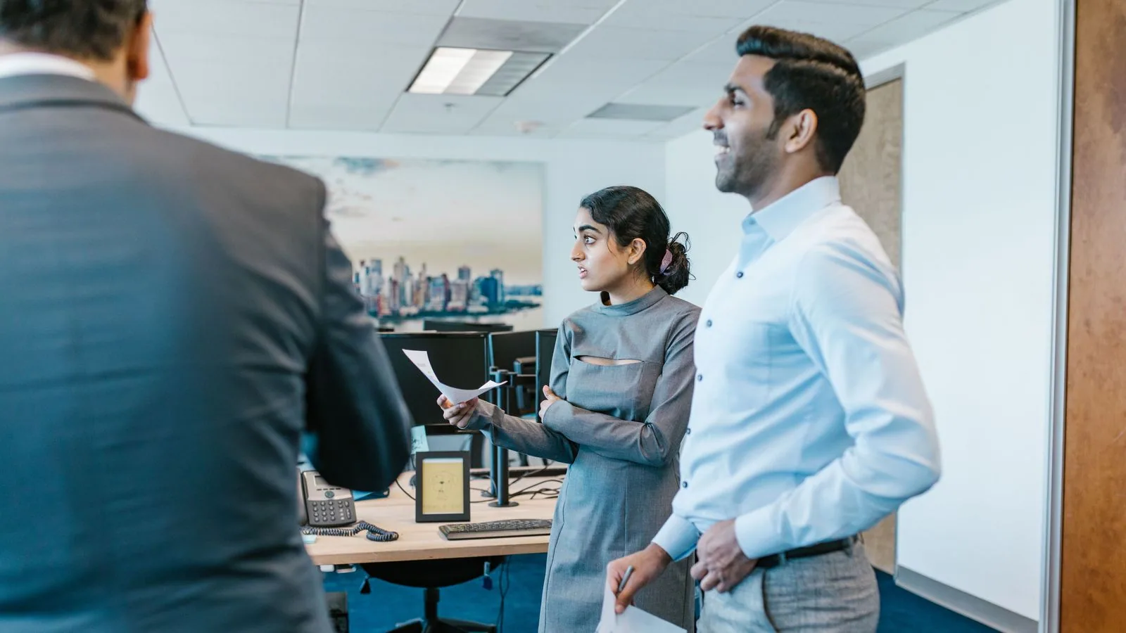 Colleagues discussing a project in an office