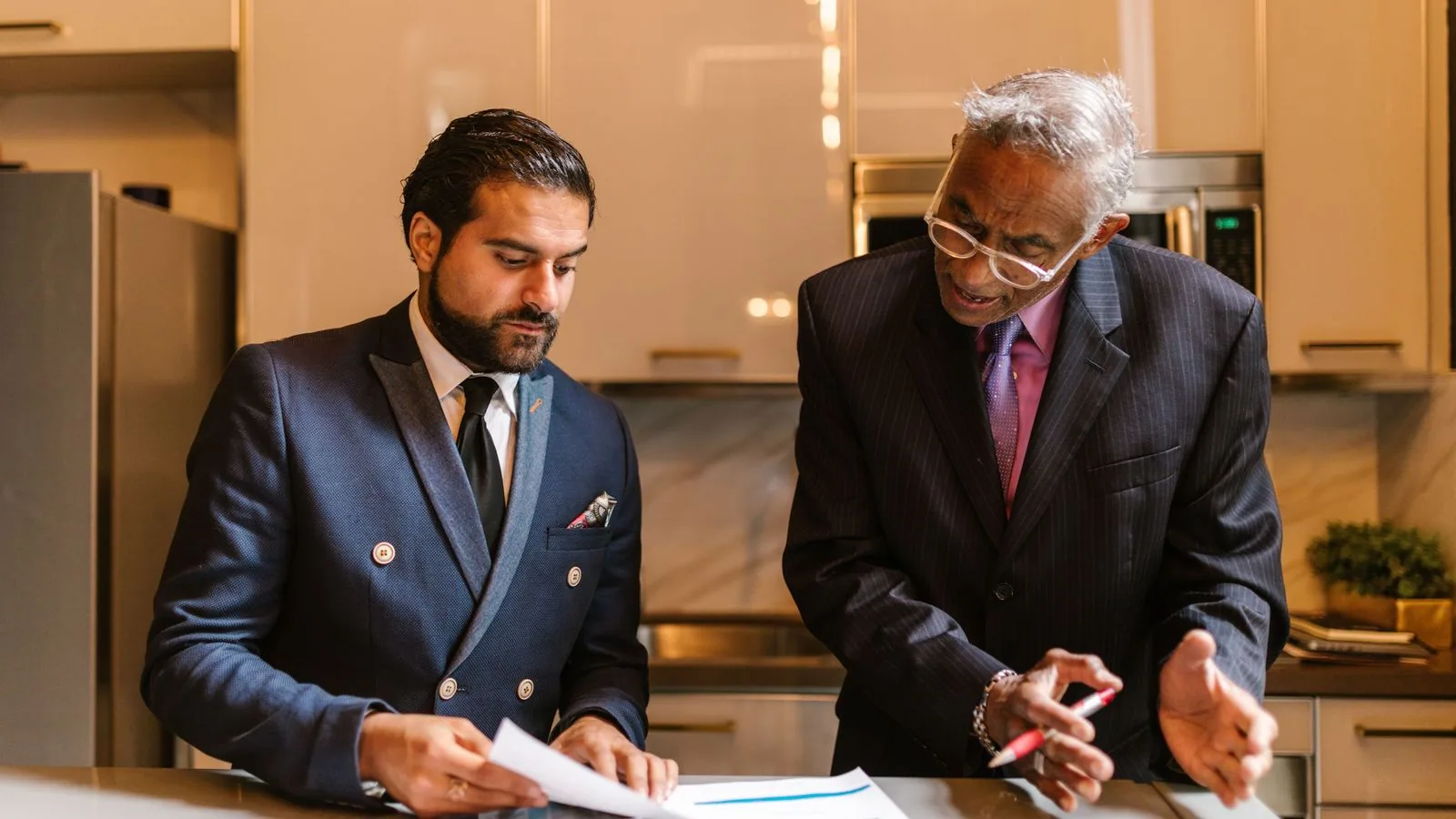 Two businesspeople discussing printed charts together