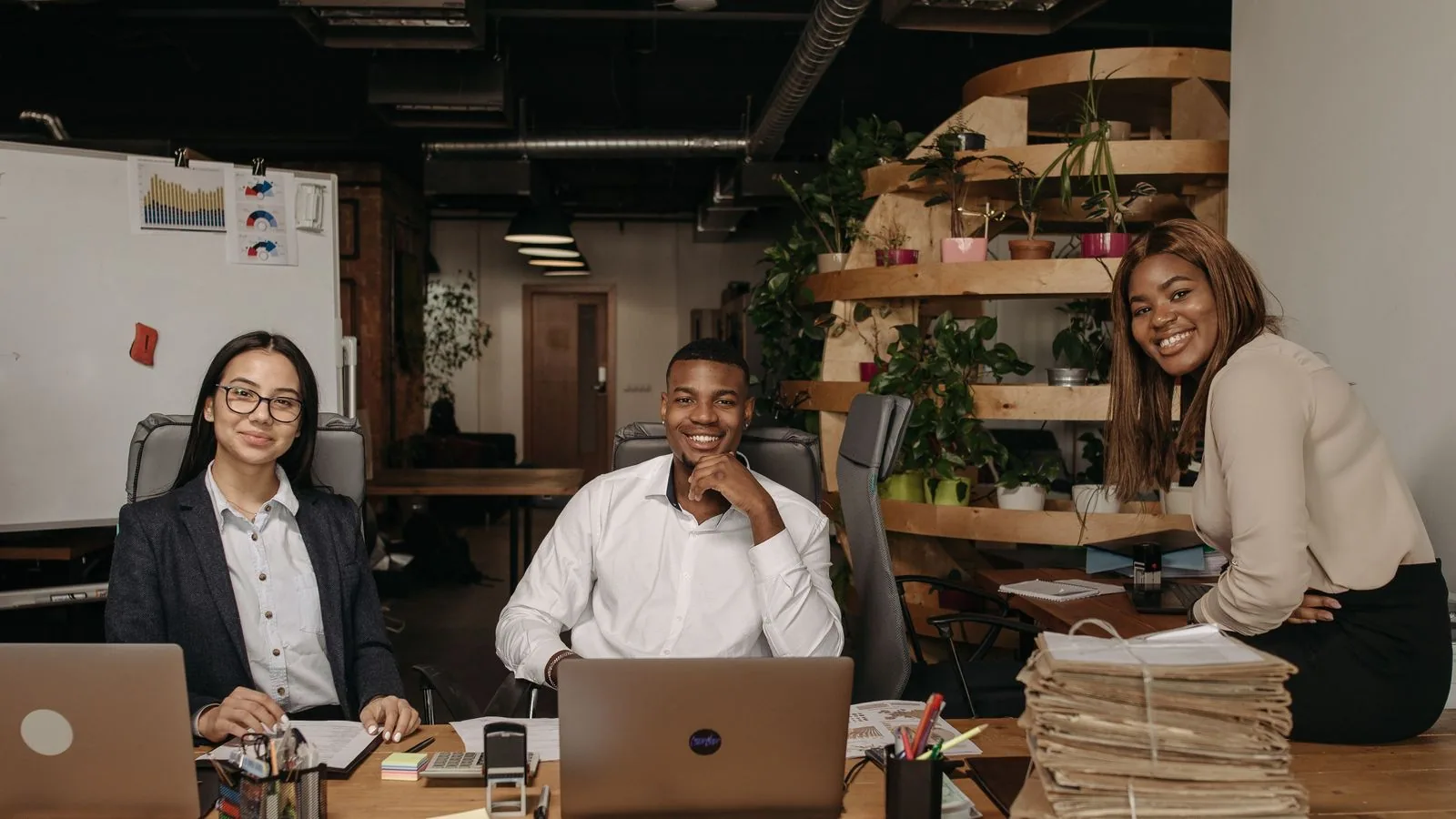 Colleagues working with a laptop and paper files