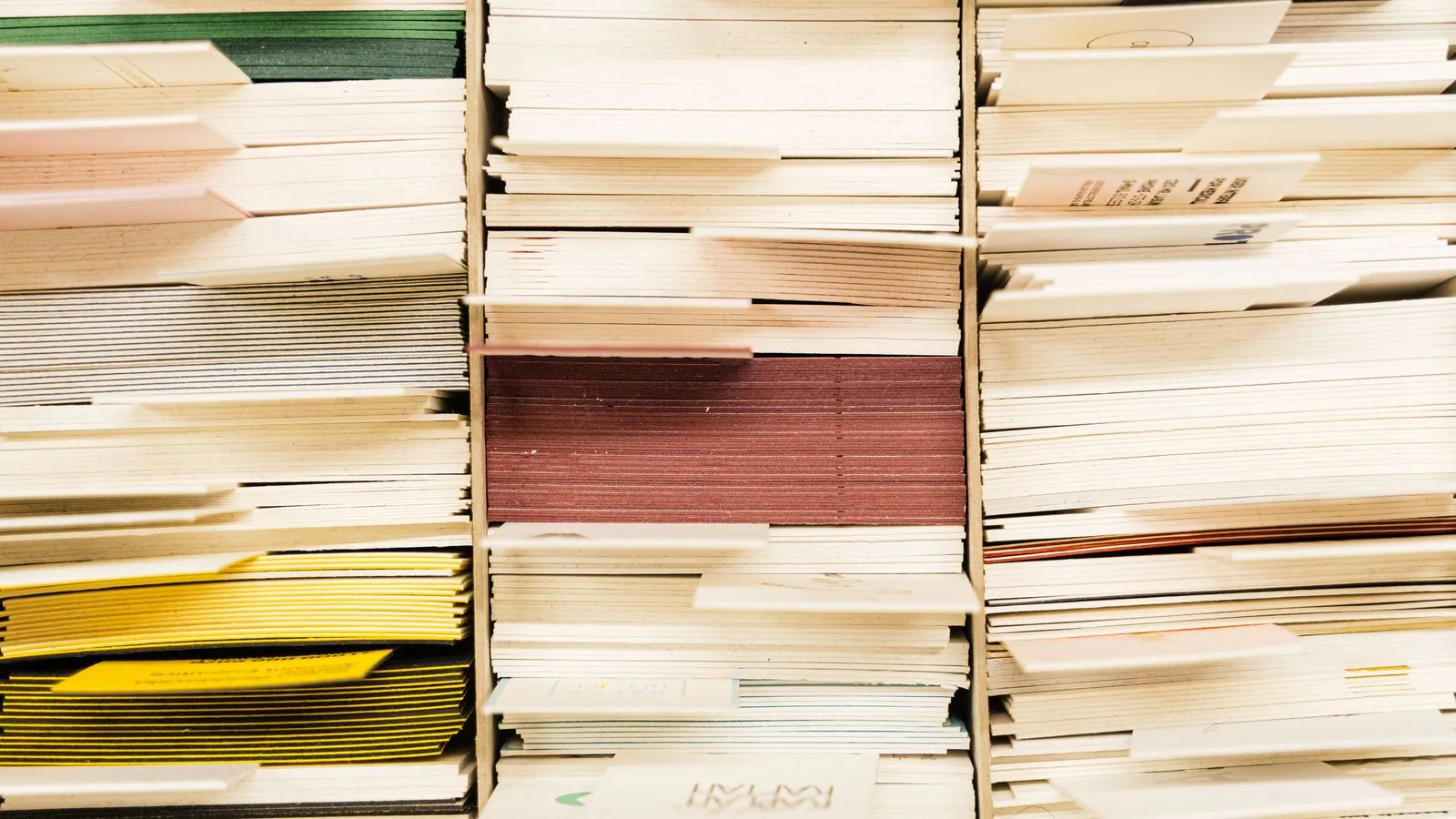 Paper documents arranged in labelled filing compartments