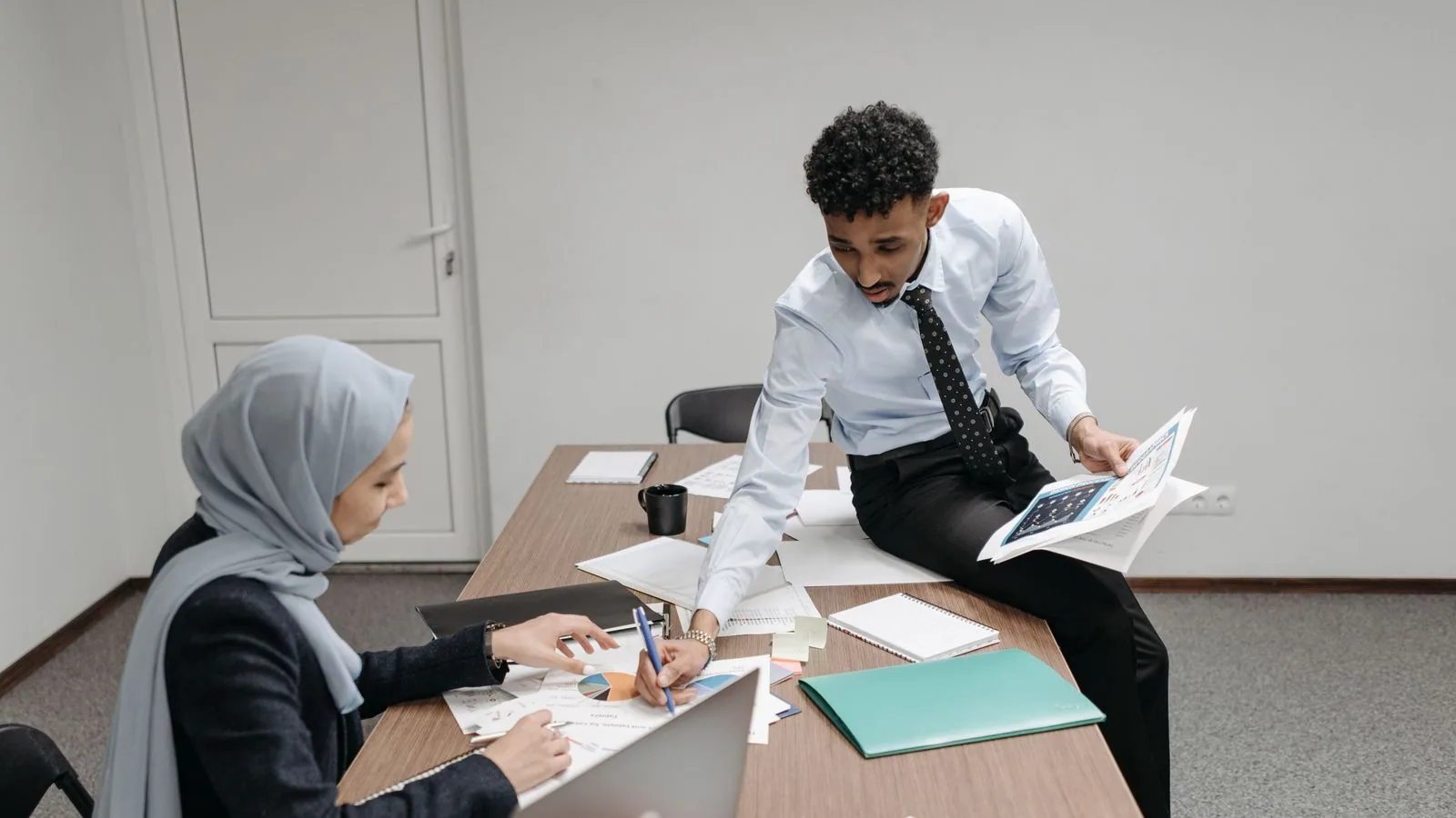 Colleagues discussing documents at an office table