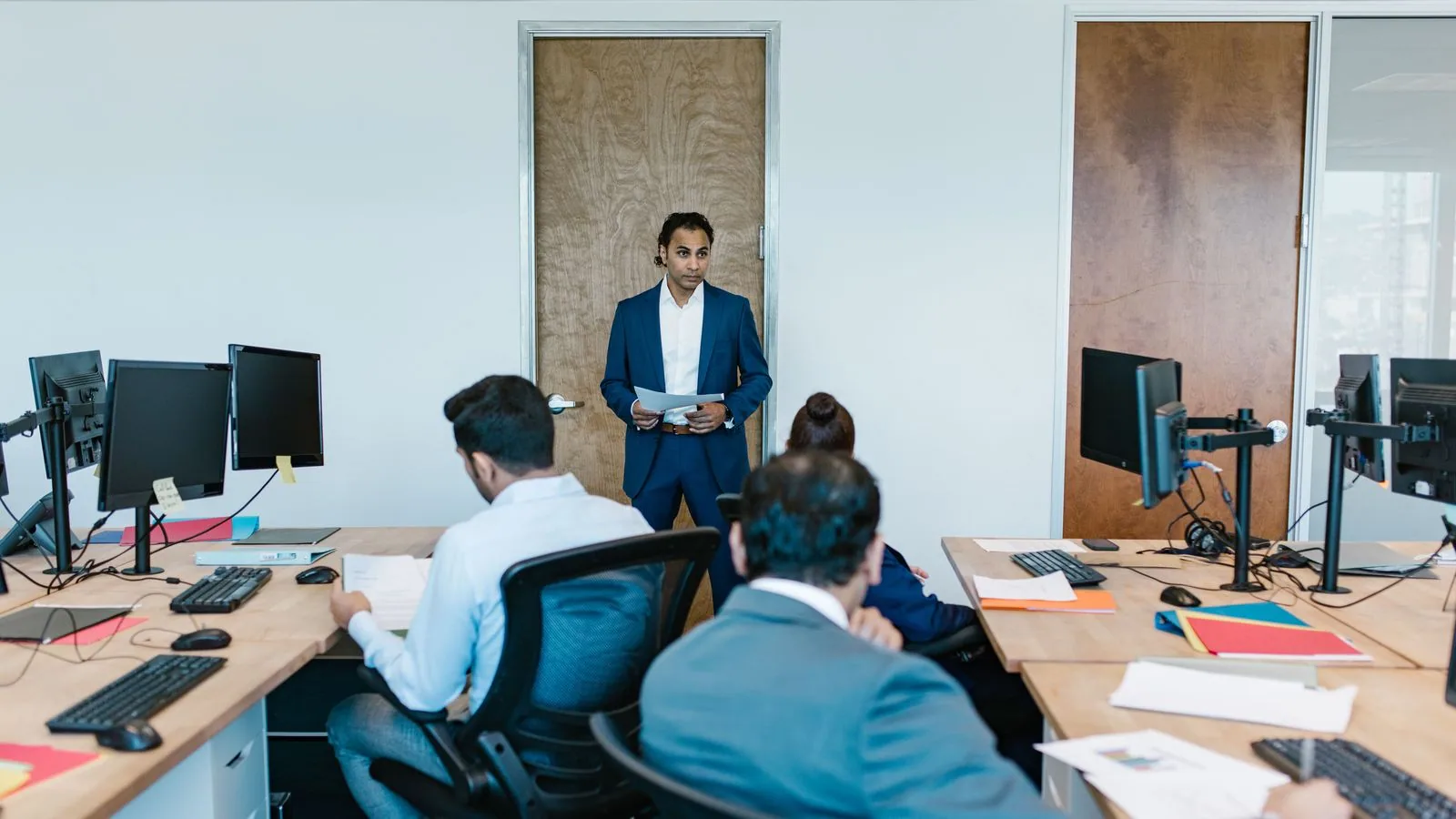 Colleagues listening to a presentation in an office