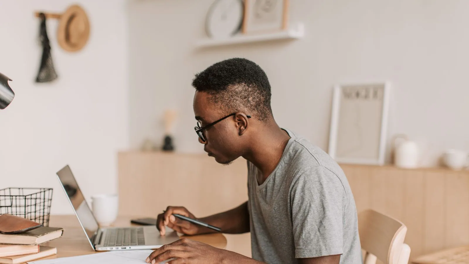 A man working on a laptop at a table indoors