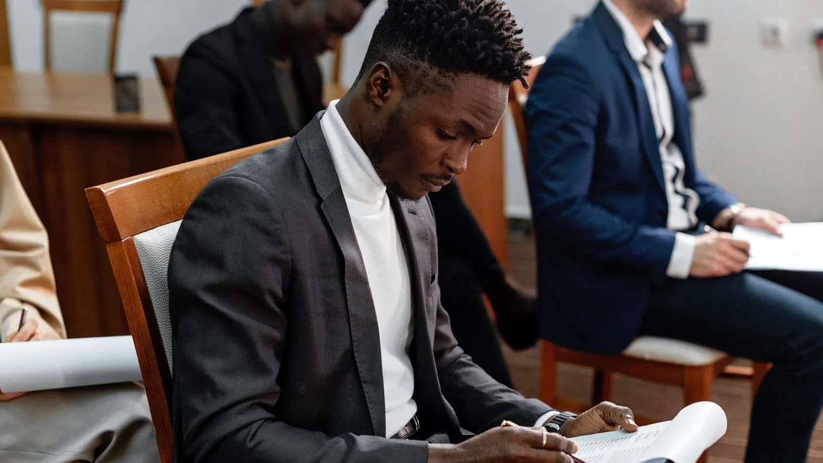 A person taking notes during a business meeting