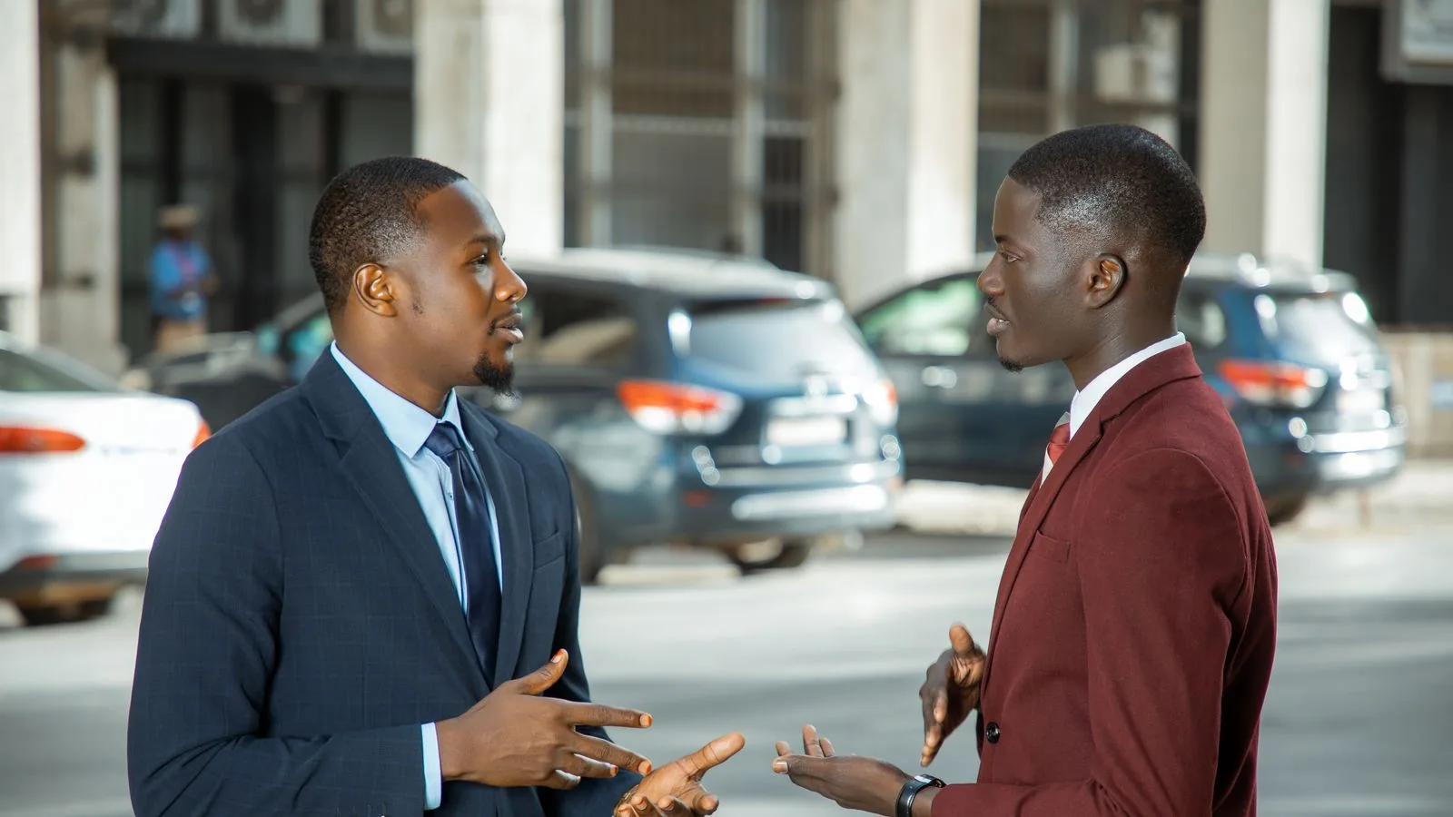 Two businesspeople discussing work outside a building