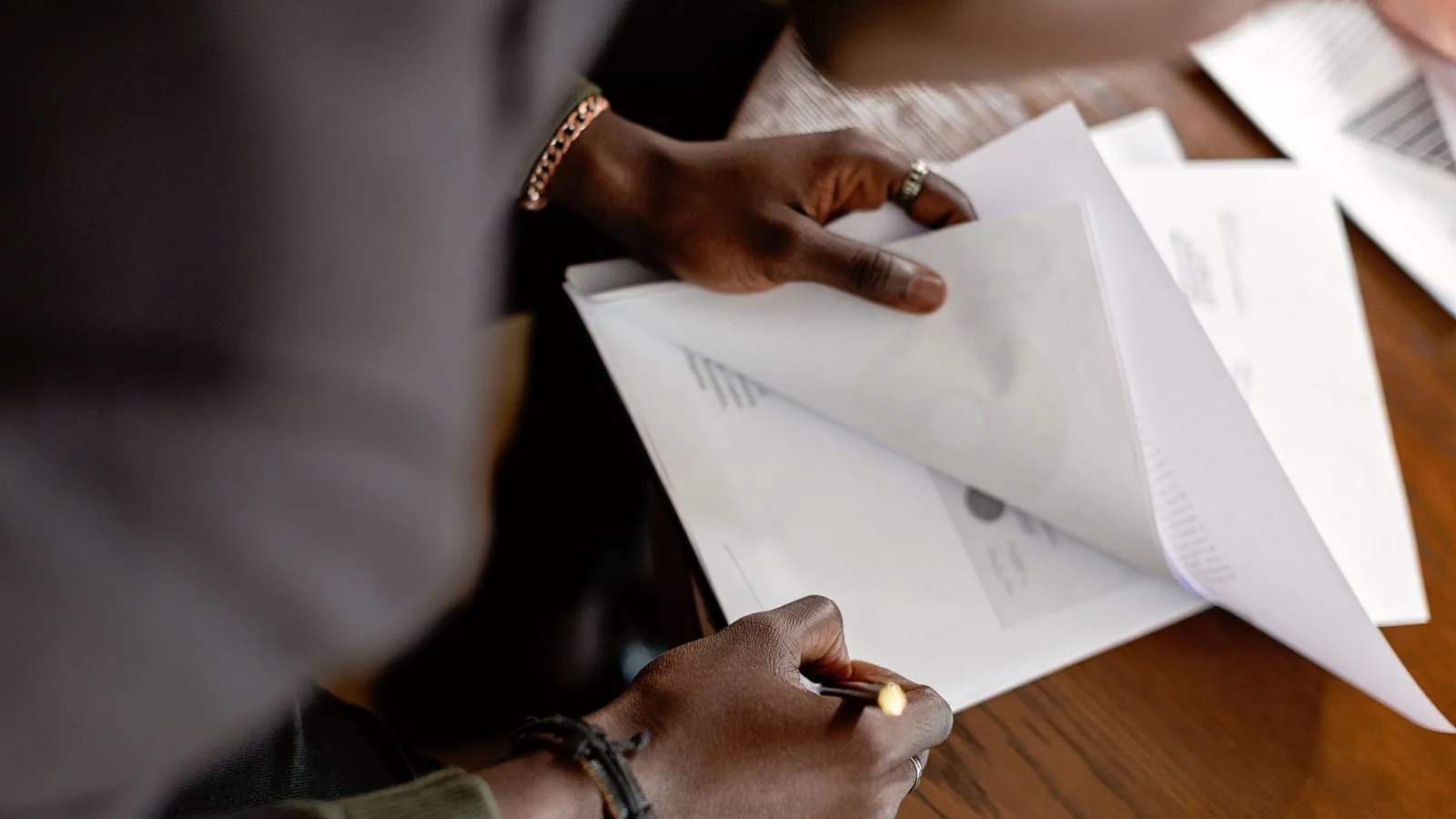 A person checking a printed document with a pen