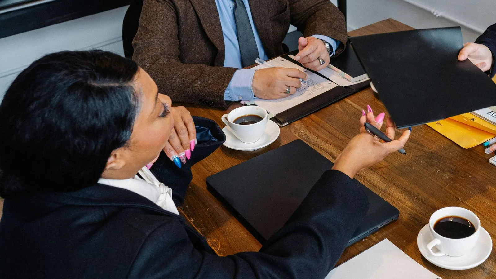 People reviewing documents around a meeting table