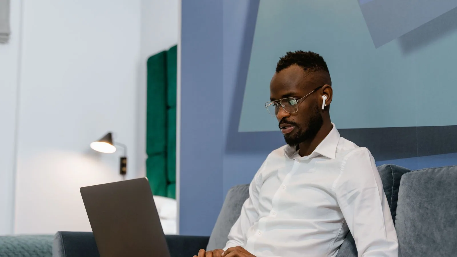 A man using a laptop in a home workspace