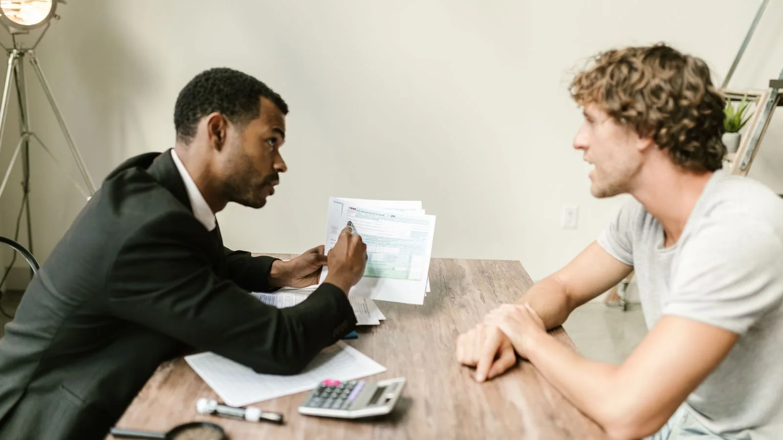 An adviser explaining a document across a table