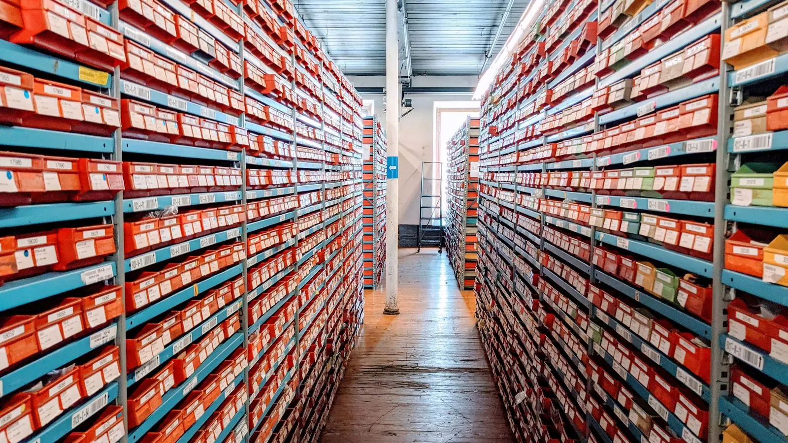 Rows of labelled stock boxes on warehouse shelves