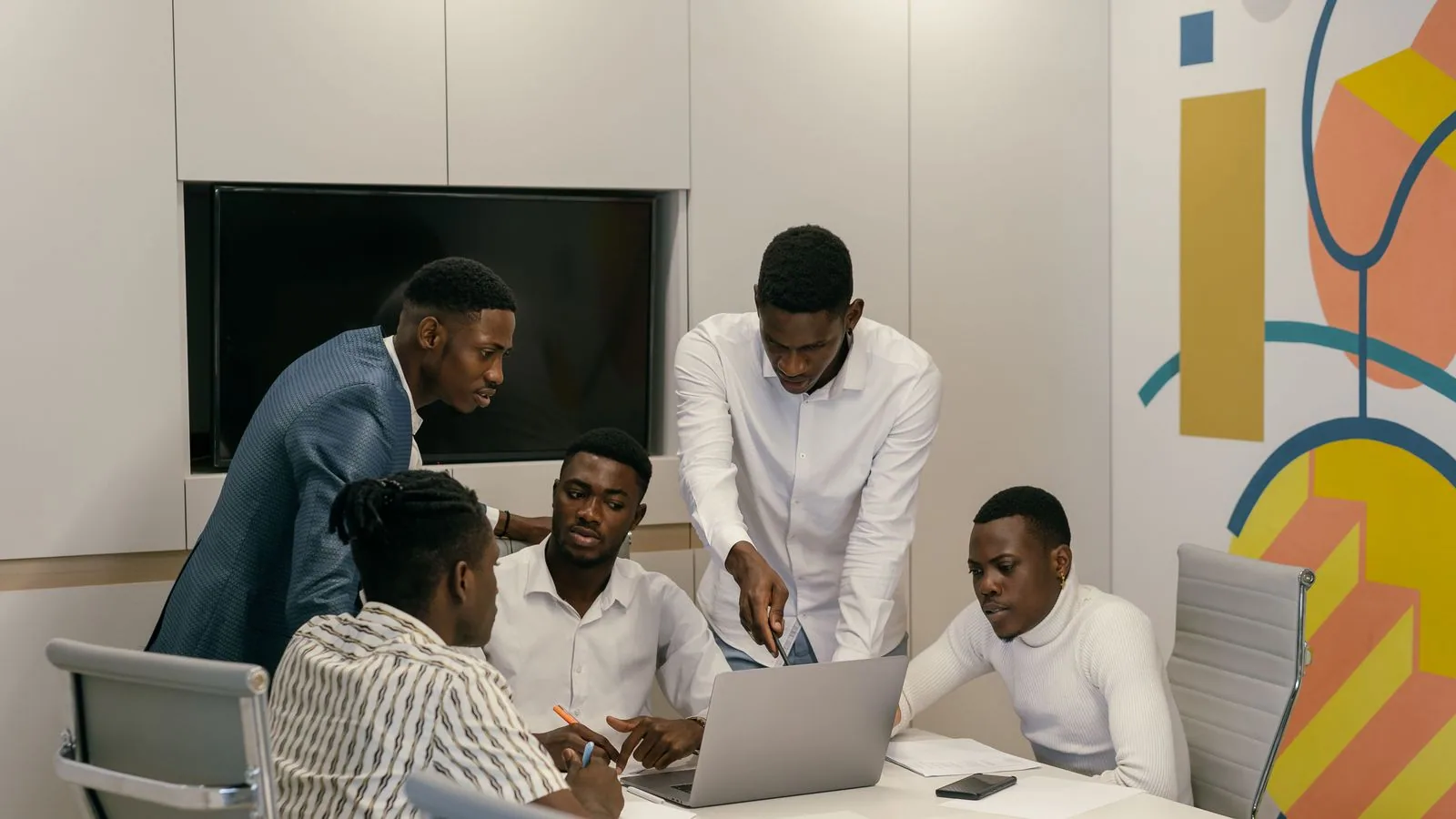 A group of colleagues comparing information at a meeting table