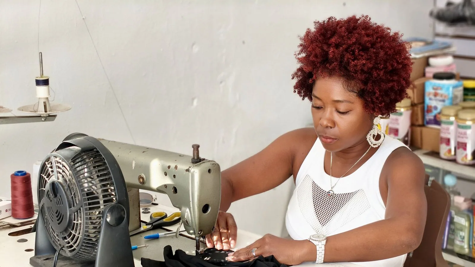 A tailor working with fabric at a sewing machine