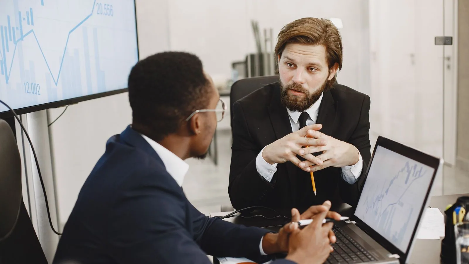 Two businesspeople discussing financial documents