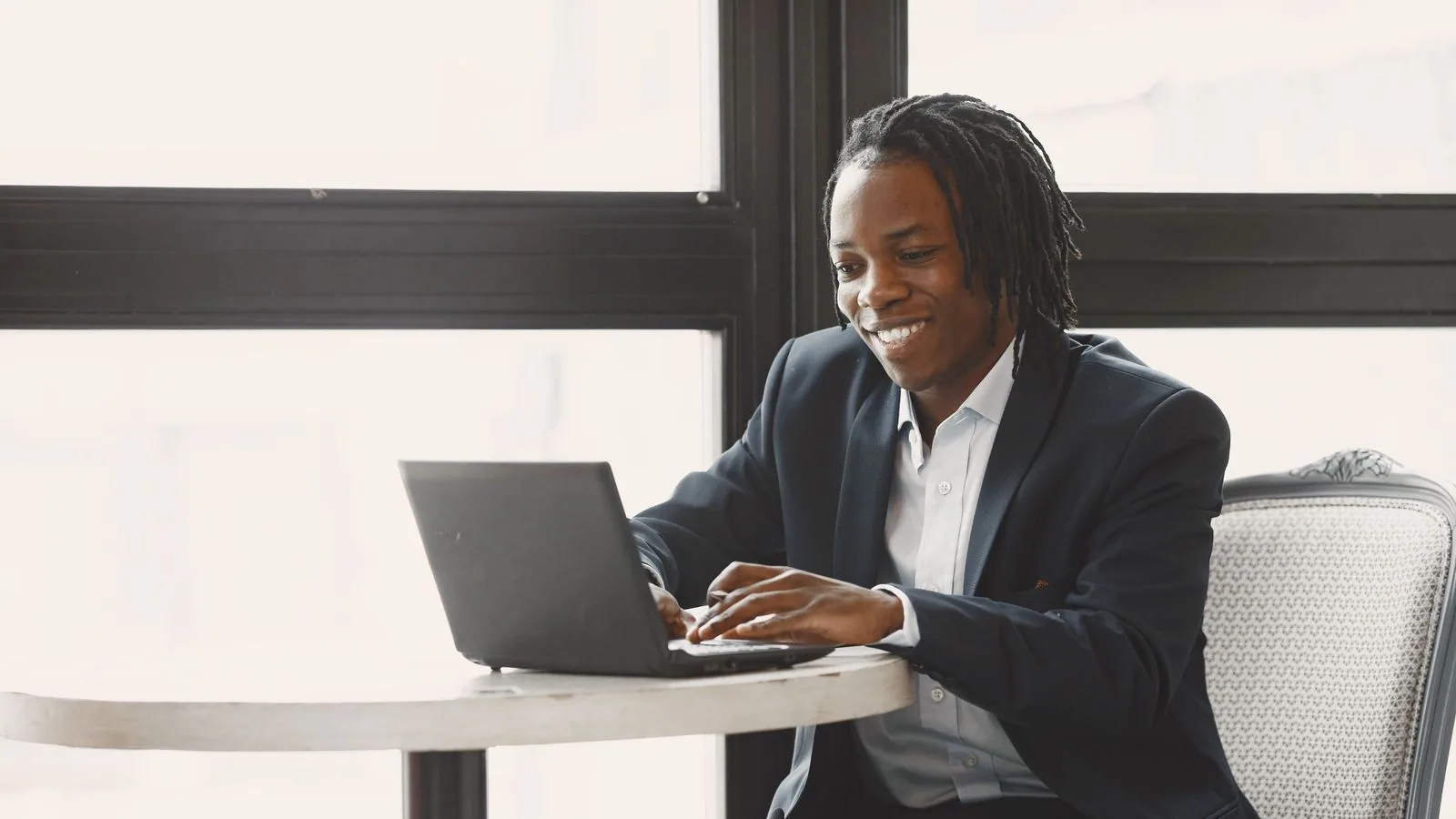 A man working on a laptop at an office table