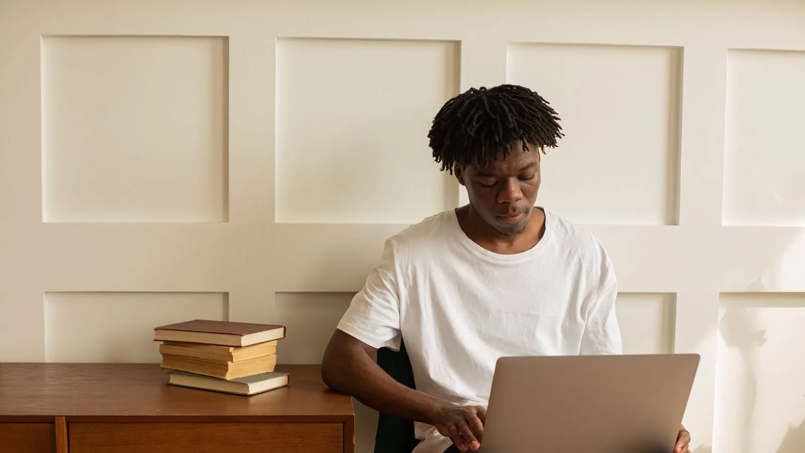 A man using a laptop while seated indoors