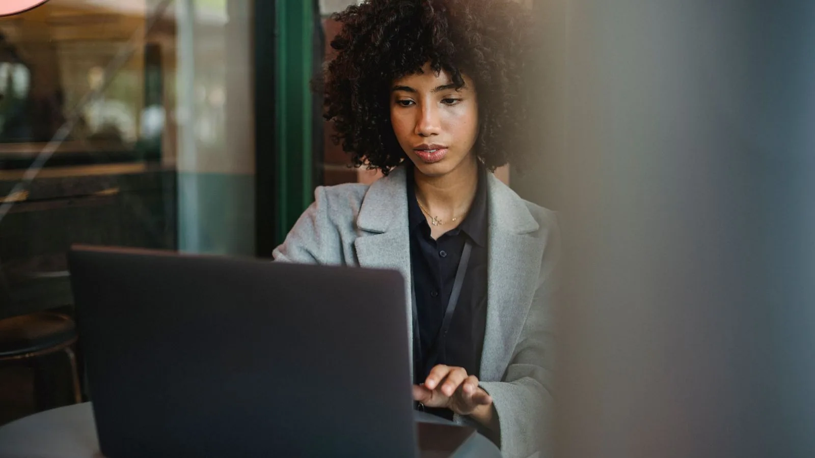 A woman working on a laptop at a round table