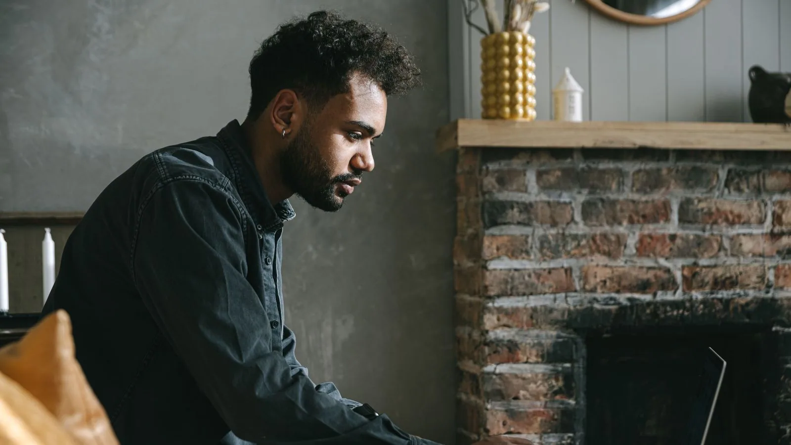 A man using a laptop in a living-room workspace