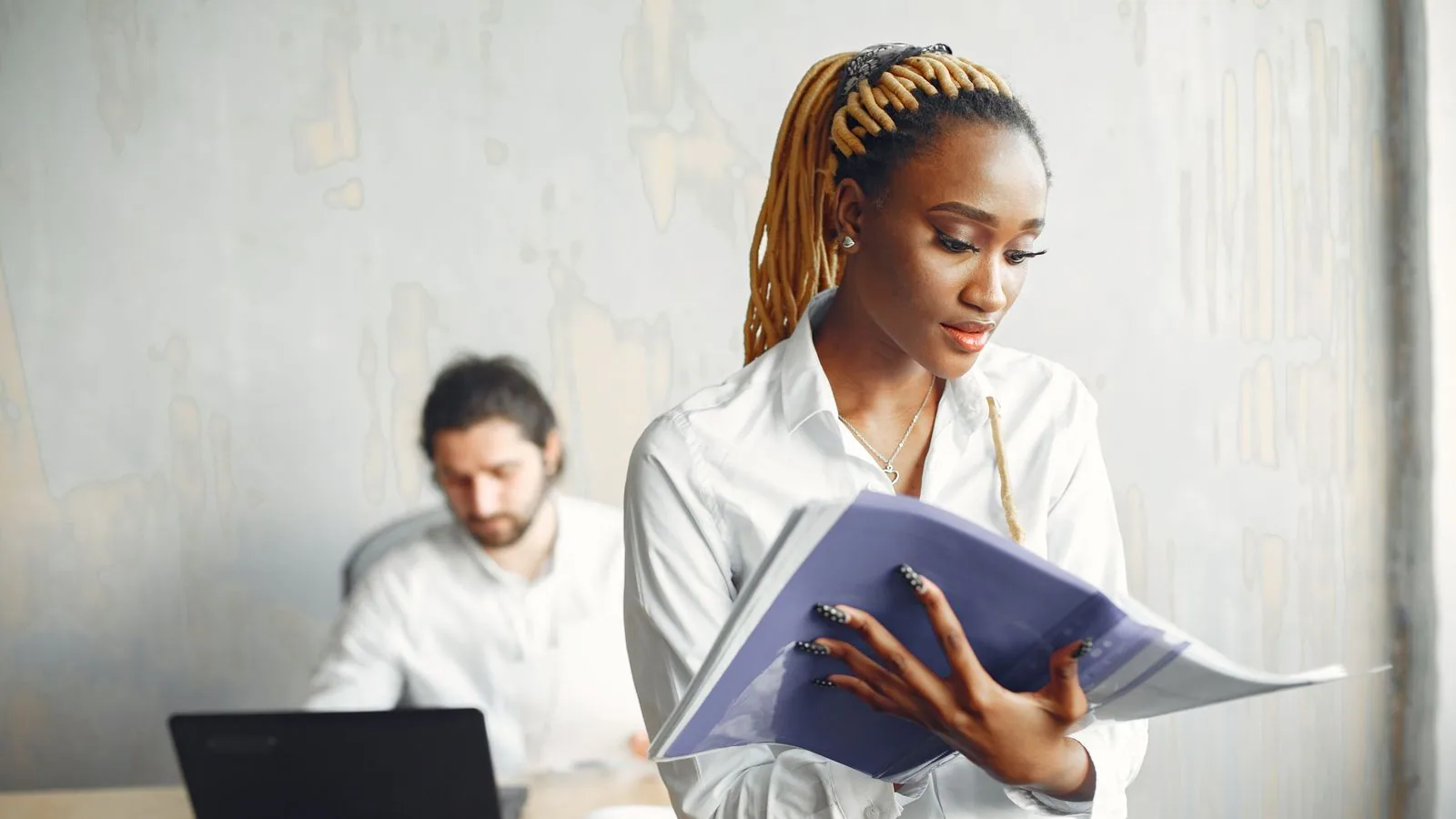 A woman checking a notebook in a shared office
