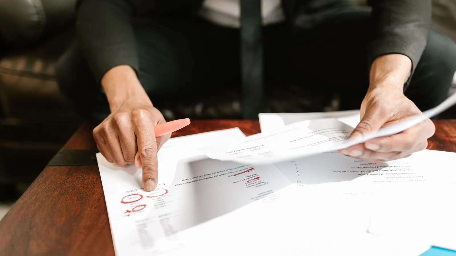 A hand pointing to figures in a financial report