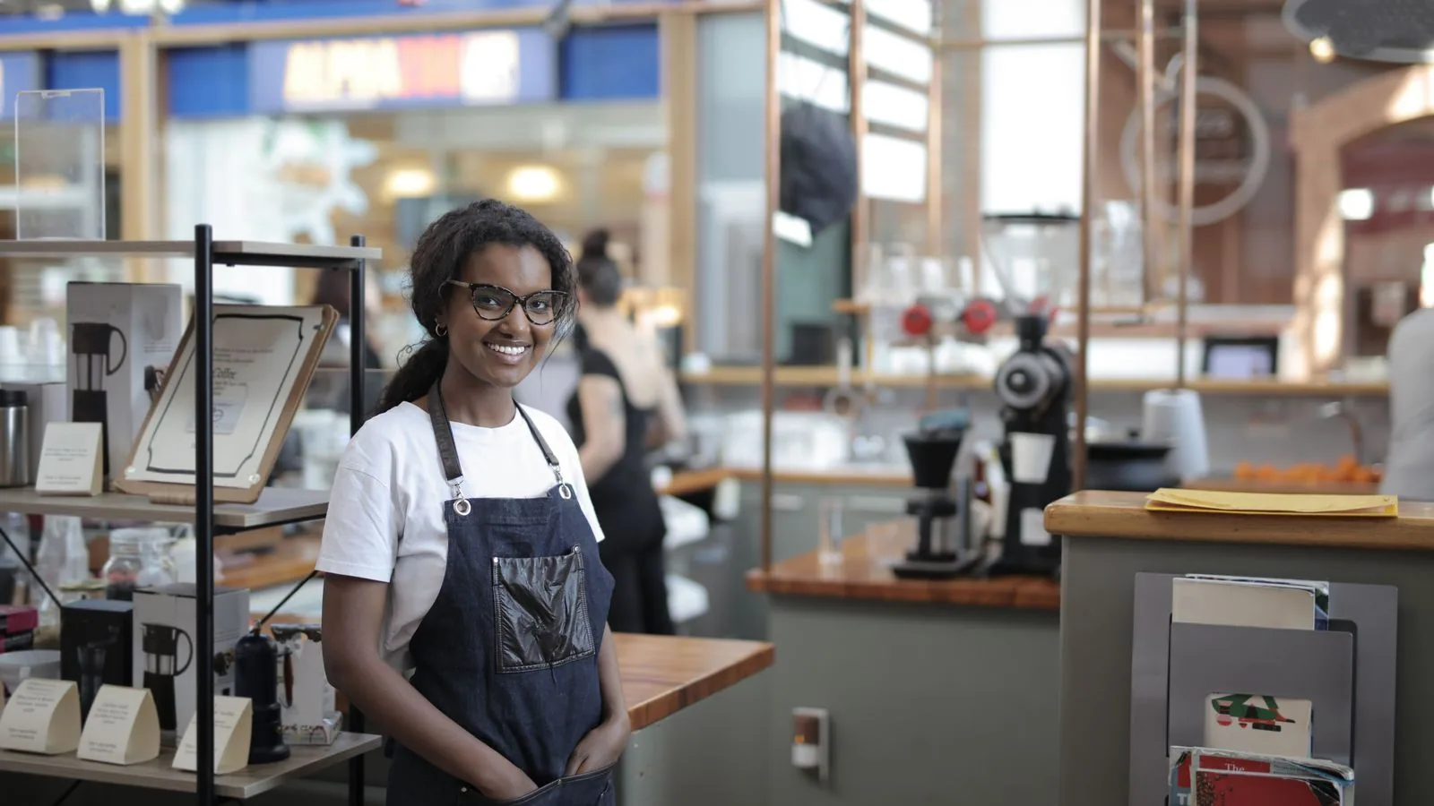 A cafe worker standing behind the counter