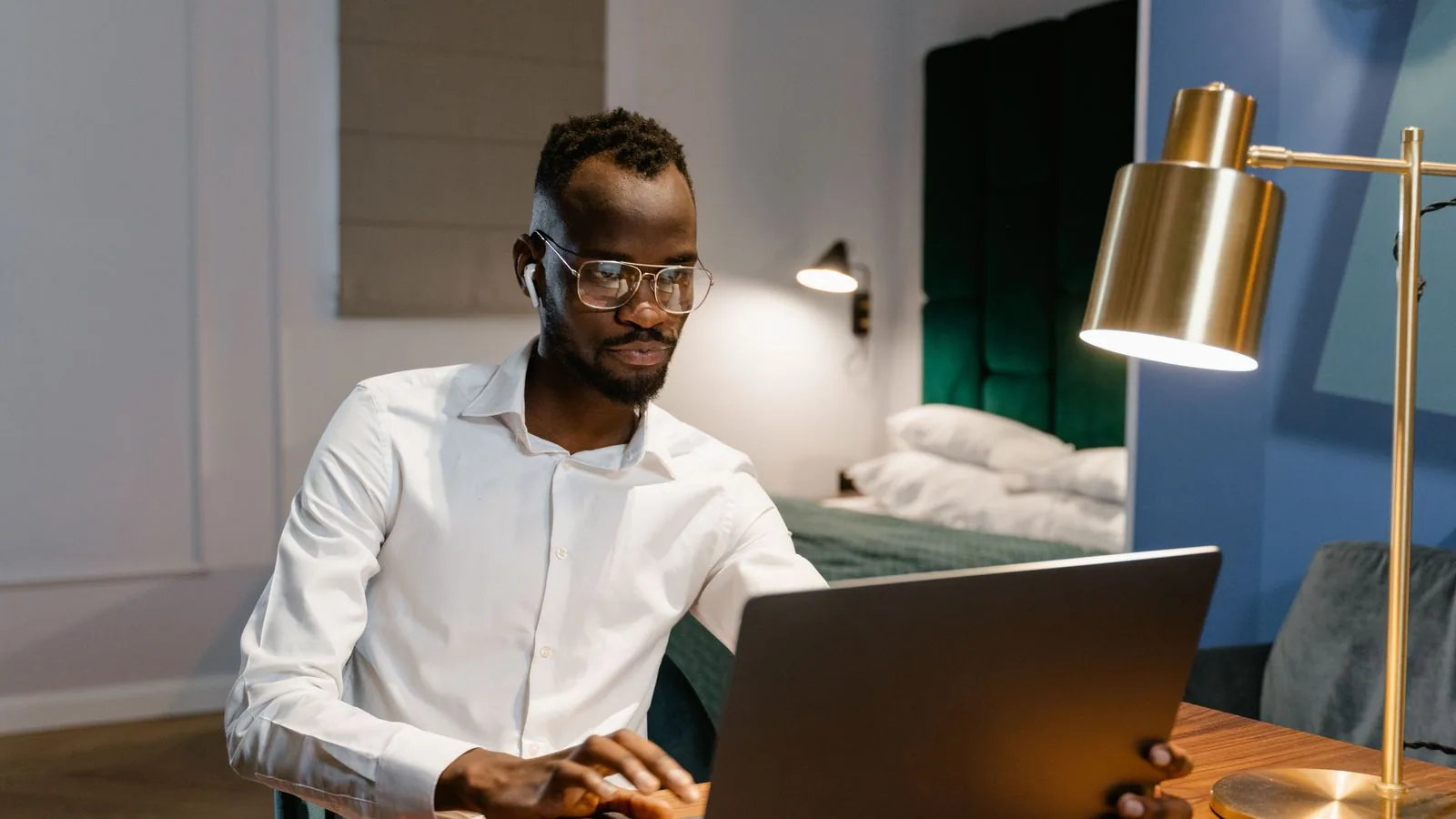 A man using a laptop in a home workspace