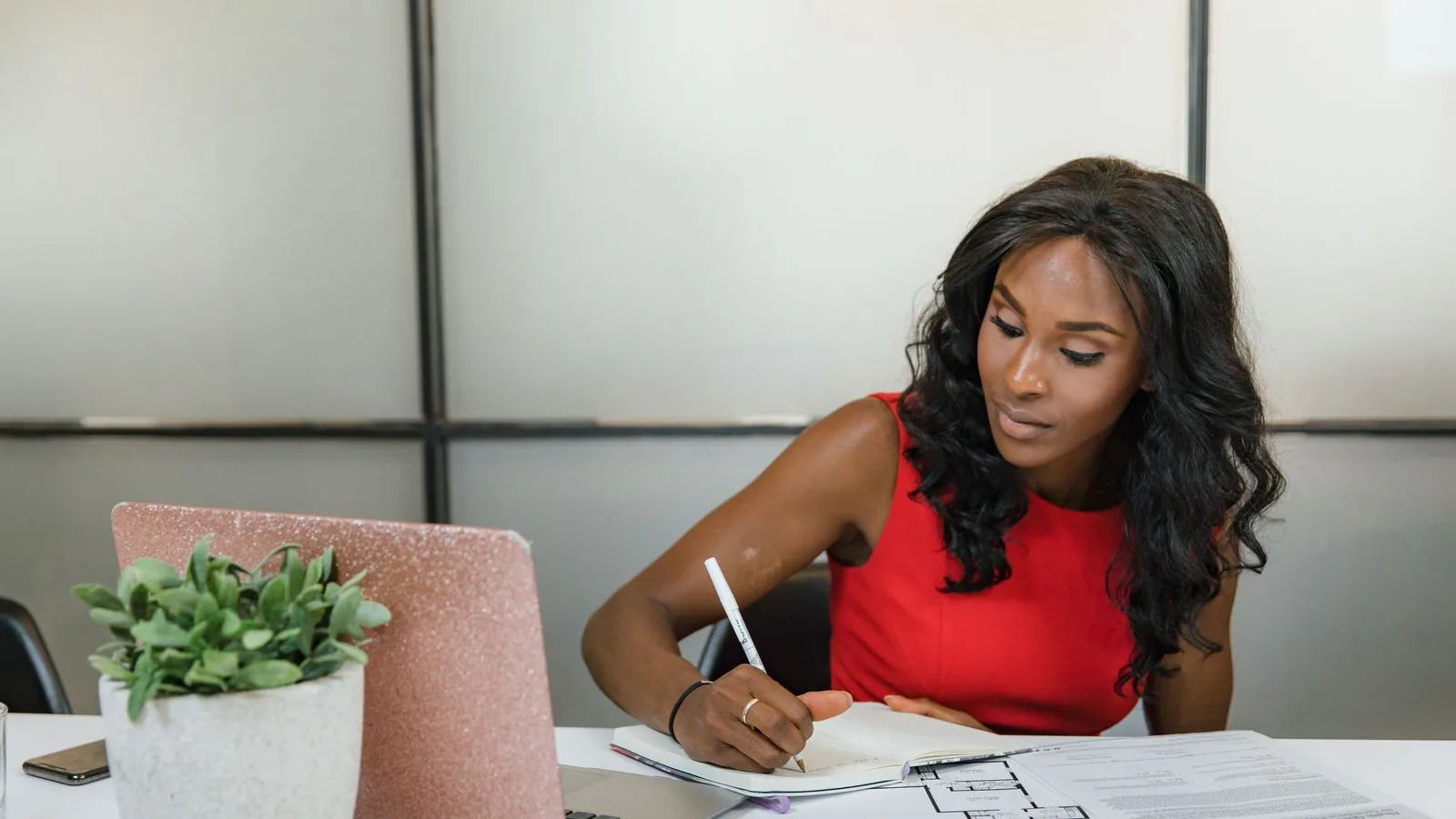 A woman checking printed papers at a desk
