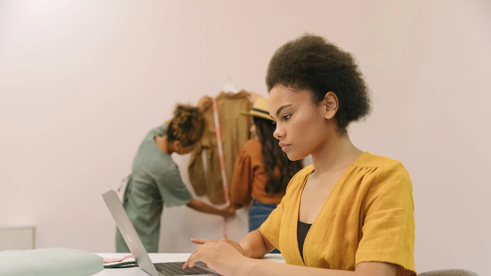 A woman working on a laptop in a shared workspace