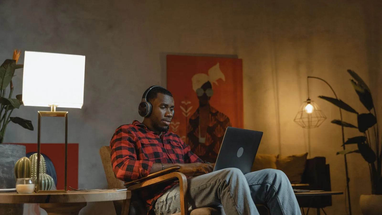 A man working on a laptop while seated on a sofa