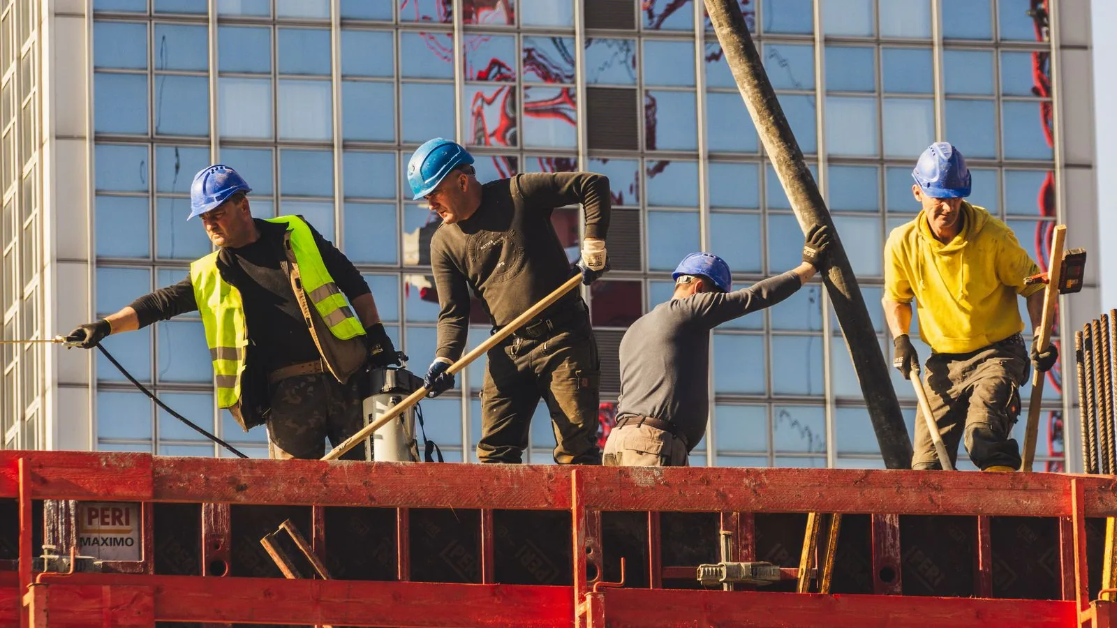 Construction workers wearing hard hats and reflective vests
