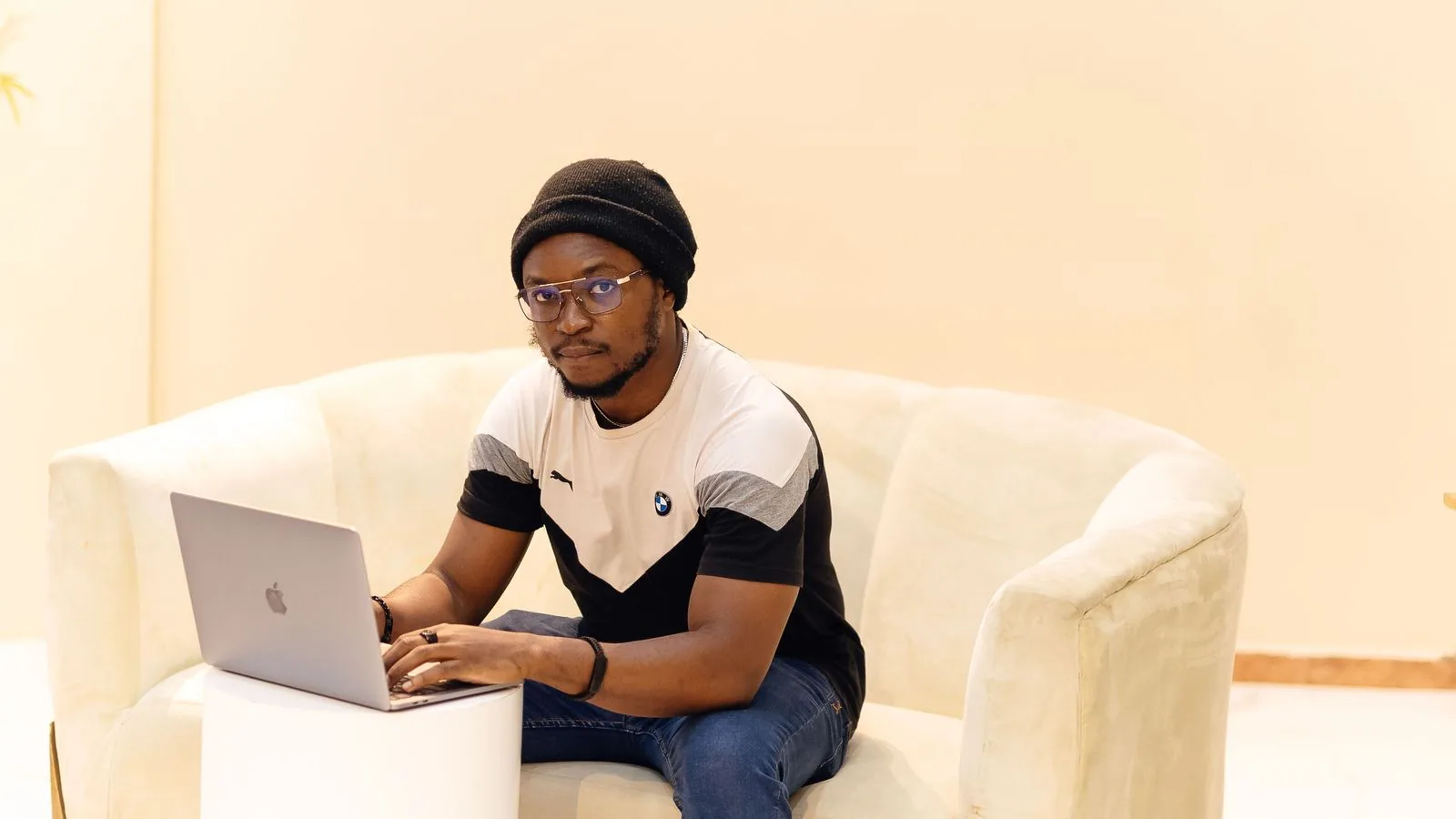 A person working on a laptop from a sofa